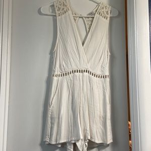 Women’s short white romper with open back. Size medium